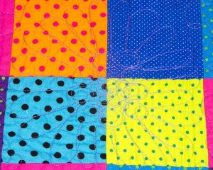 Dotty-About-You-patchwork-cot-quilt-close-up-Q000117