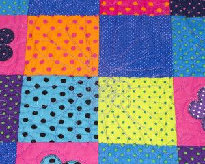Dotty-About-You-patchwork-cot-quilt-close-up