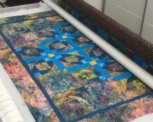 Customer wall quilt being quilted with curls and swirls pattern