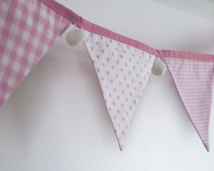 Baby pink bunting with white pom-poms