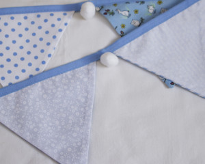 Rabbits and owls blue bunting with white pom-poms showing reverse